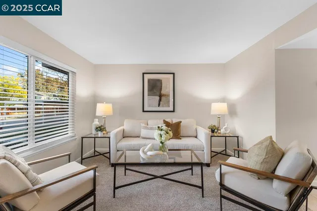 a living room with furniture and a lamp