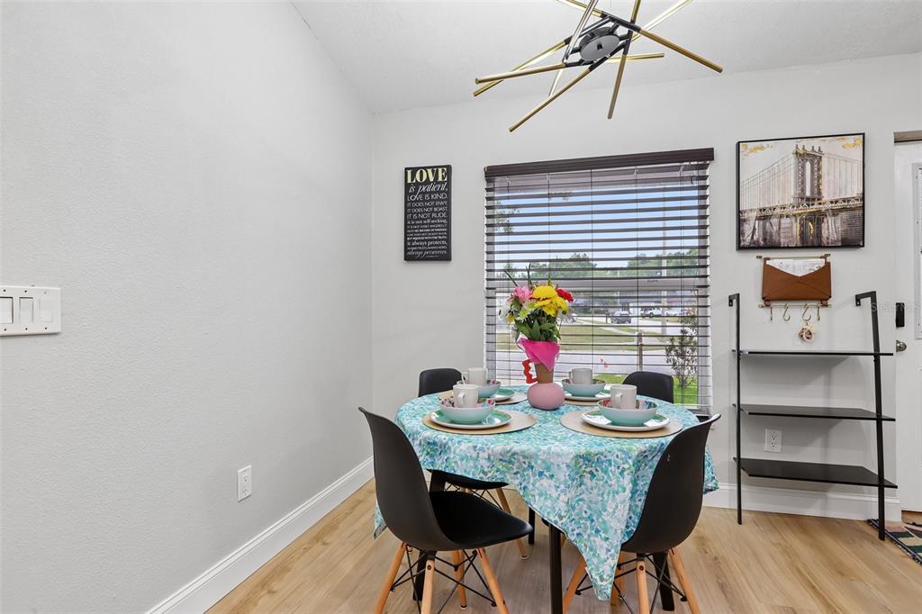 1525 Kestrel Way Brandon, FL 33511 - Photo 10 of 48 a view of a dining room with furniture and wooden floor