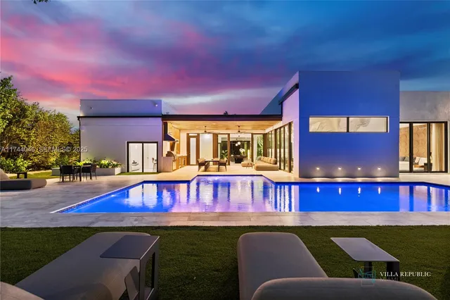 a view of a chairs and tables in the patio in front of a house