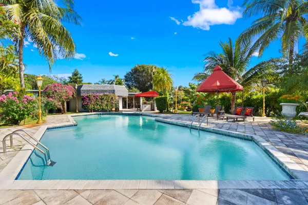 a view of a house with pool and sitting area