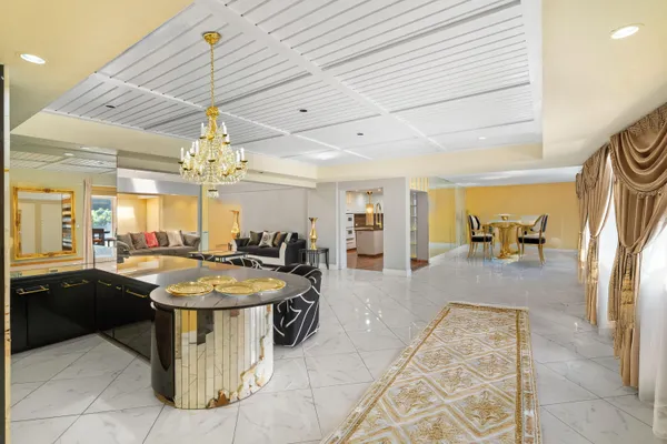 a living room with furniture and a chandelier