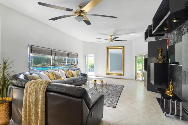 a living room with furniture and a chandelier