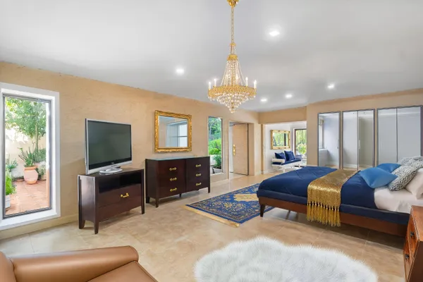 a living room with furniture and a chandelier