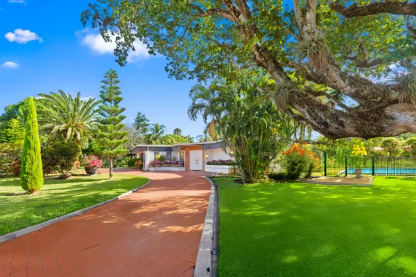 a view of a park with a house in the background