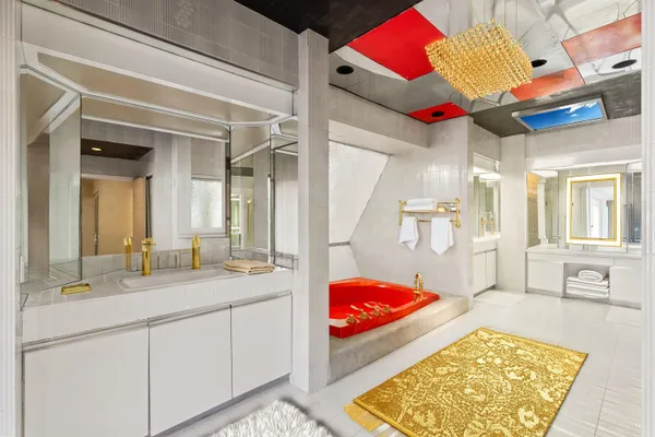 a bathroom with a granite countertop sink mirror vanity and toilet