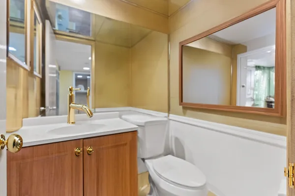 a large kitchen with kitchen island a sink a stove and a refrigerator