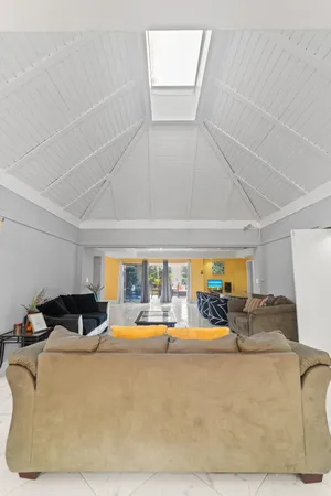 a bedroom with a bed and a lamp on dresser