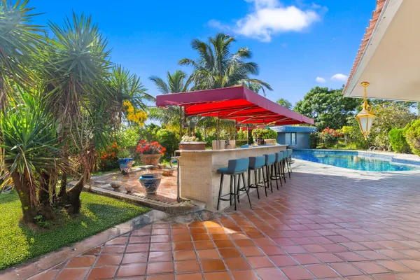 a view of a patio with table and chairs under an umbrella