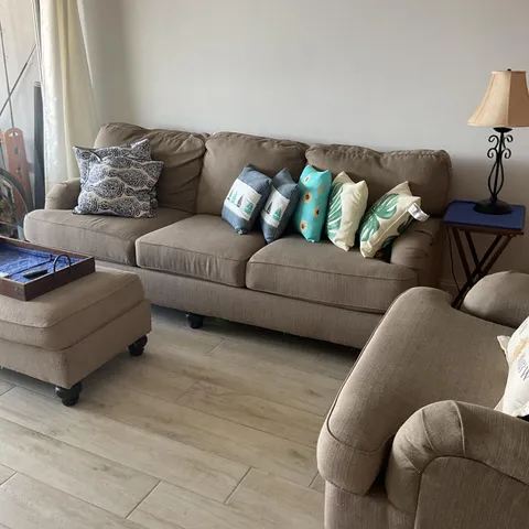 a living room with furniture and a lamp