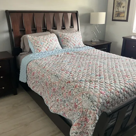 a large bed sitting in a bedroom next to a window