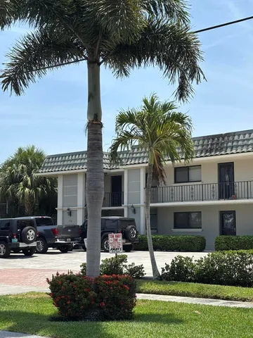 a front view of a house with yard and green space