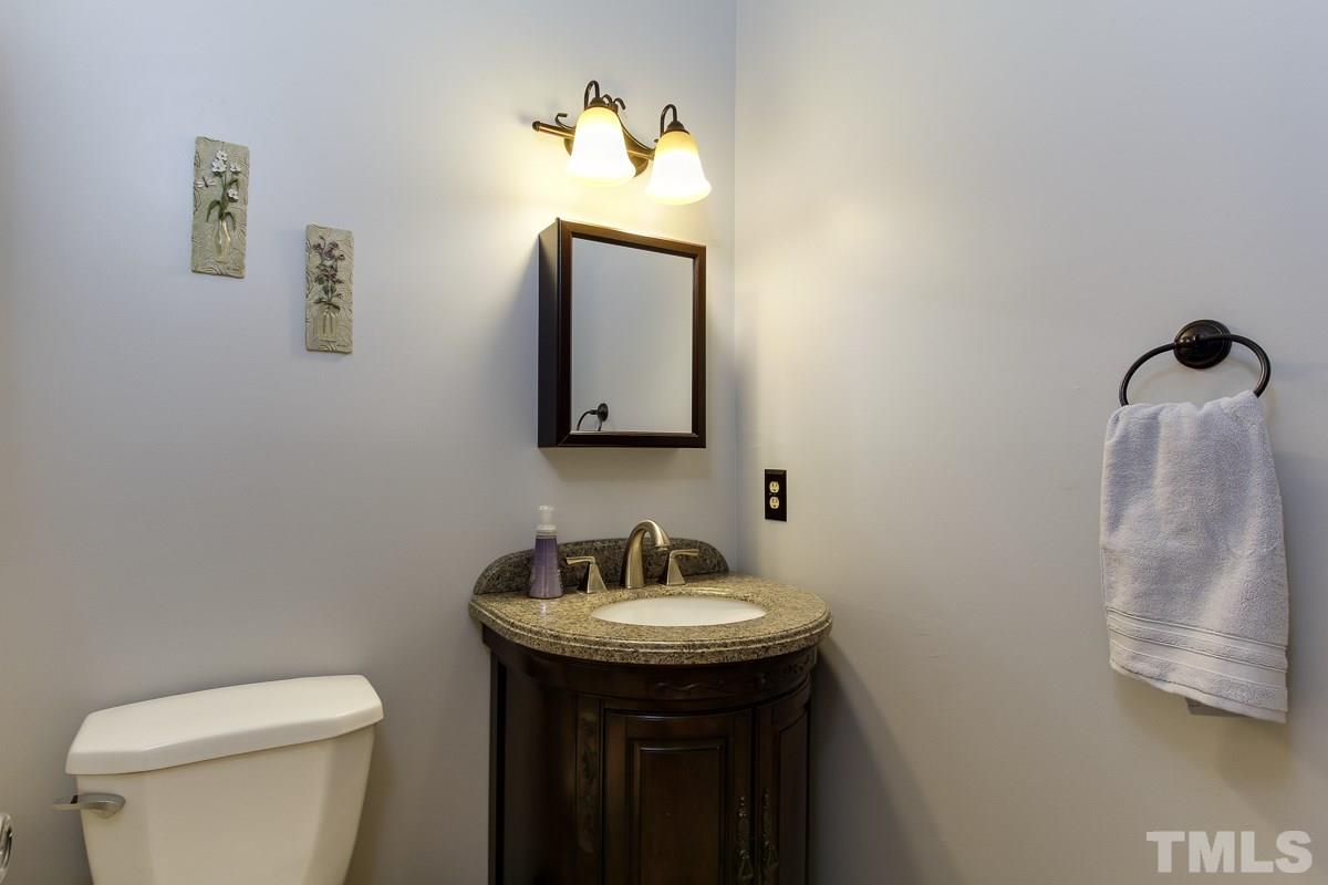 2000 Corberrie Lane Raleigh, NC 27613 - Photo 13 of 25 a bathroom with a toilet a sink and mirror