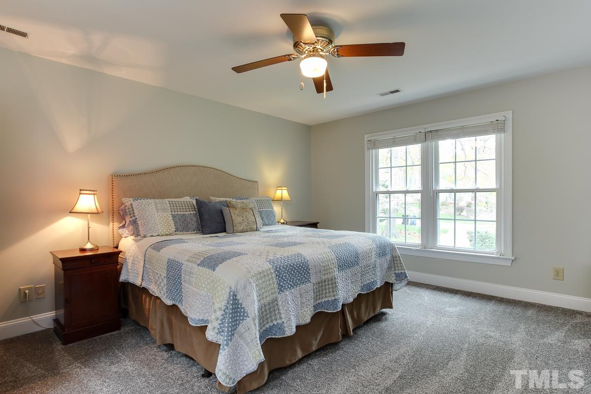 2000 Corberrie Lane Raleigh, NC 27613 - Photo 14 of 25 a bedroom with a bed lamp and a chandelier