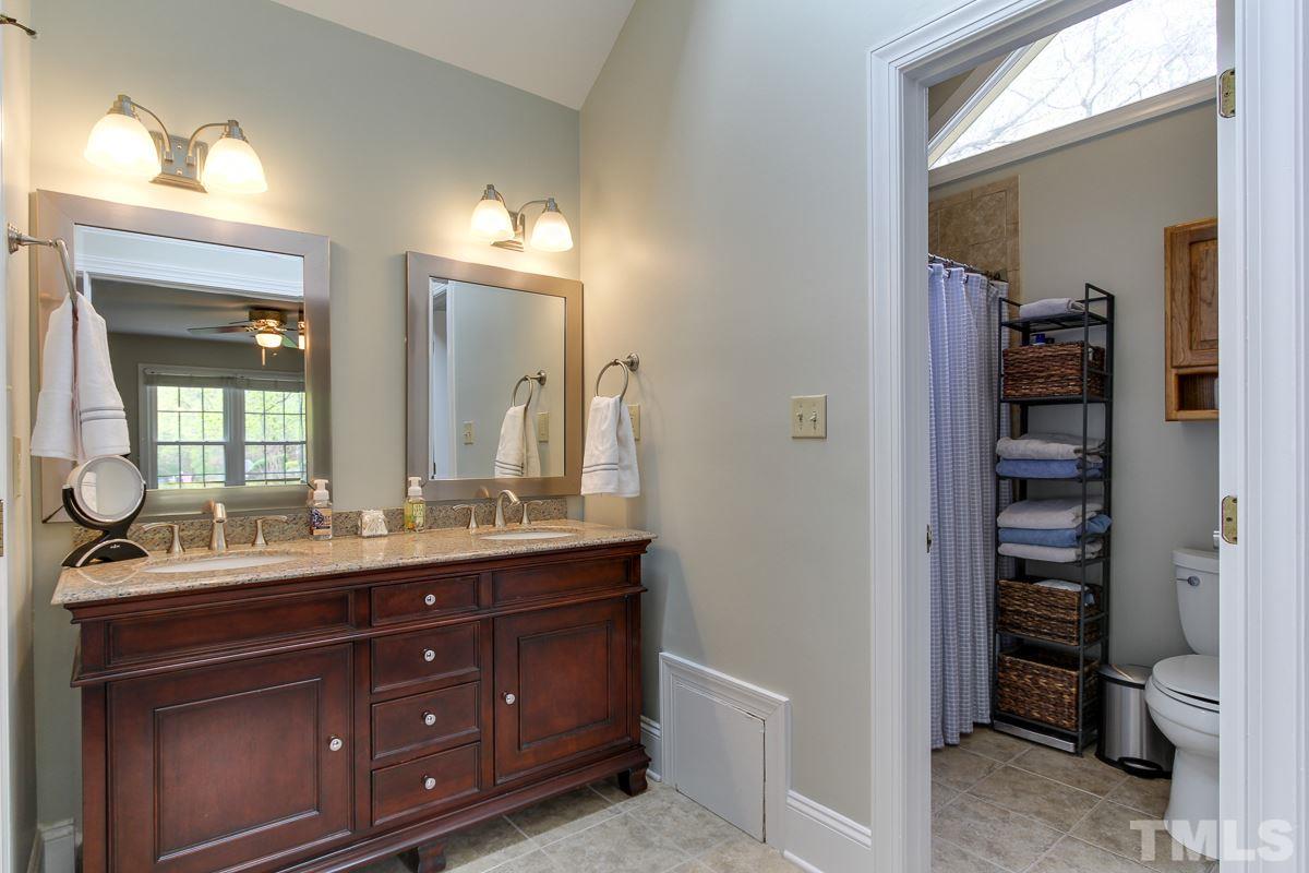 2000 Corberrie Lane Raleigh, NC 27613 - Photo 16 of 25 a bathroom with a granite countertop sink and a mirror