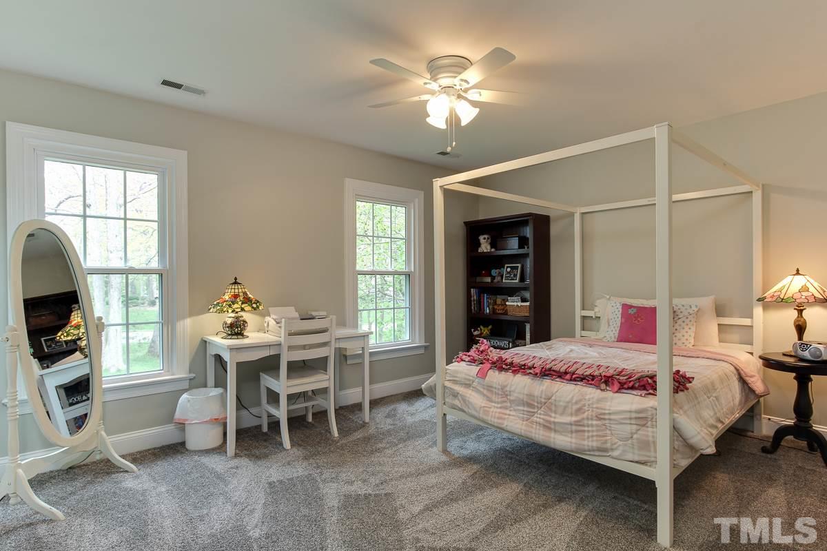 2000 Corberrie Lane Raleigh, NC 27613 - Photo 19 of 25 a bedroom with a bed and a chandelier