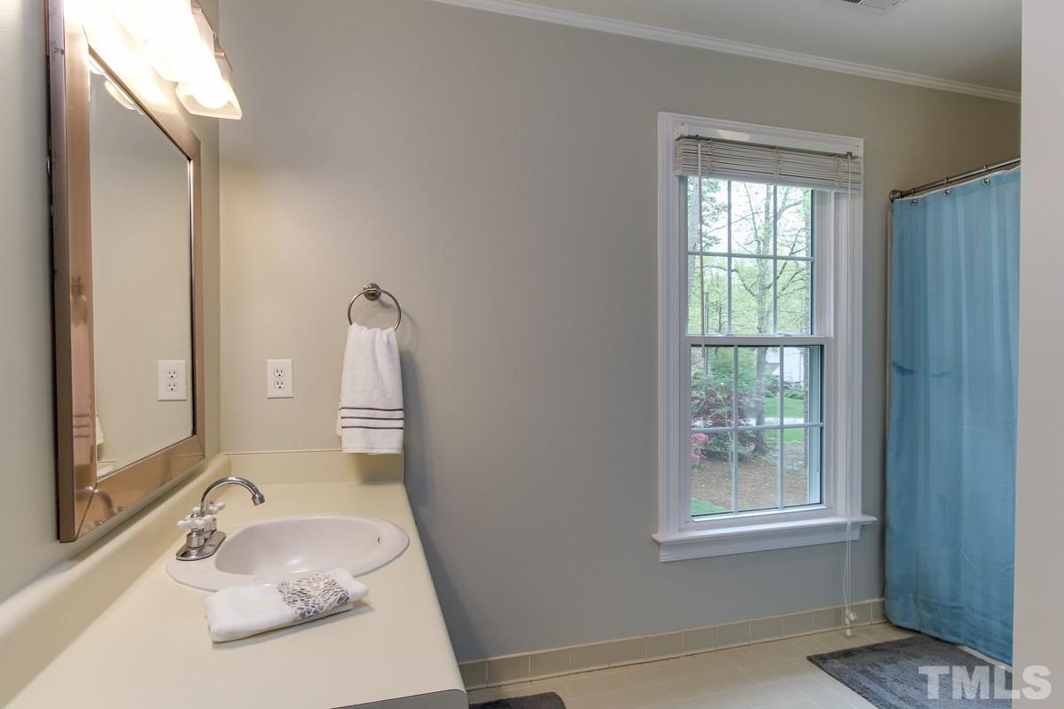 2000 Corberrie Lane Raleigh, NC 27613 - Photo 20 of 25 a bathroom with a granite countertop sink and a mirror