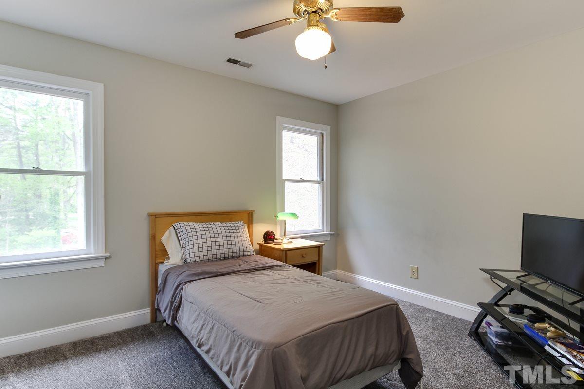 2000 Corberrie Lane Raleigh, NC 27613 - Photo 22 of 25 a bedroom with a bed and a window