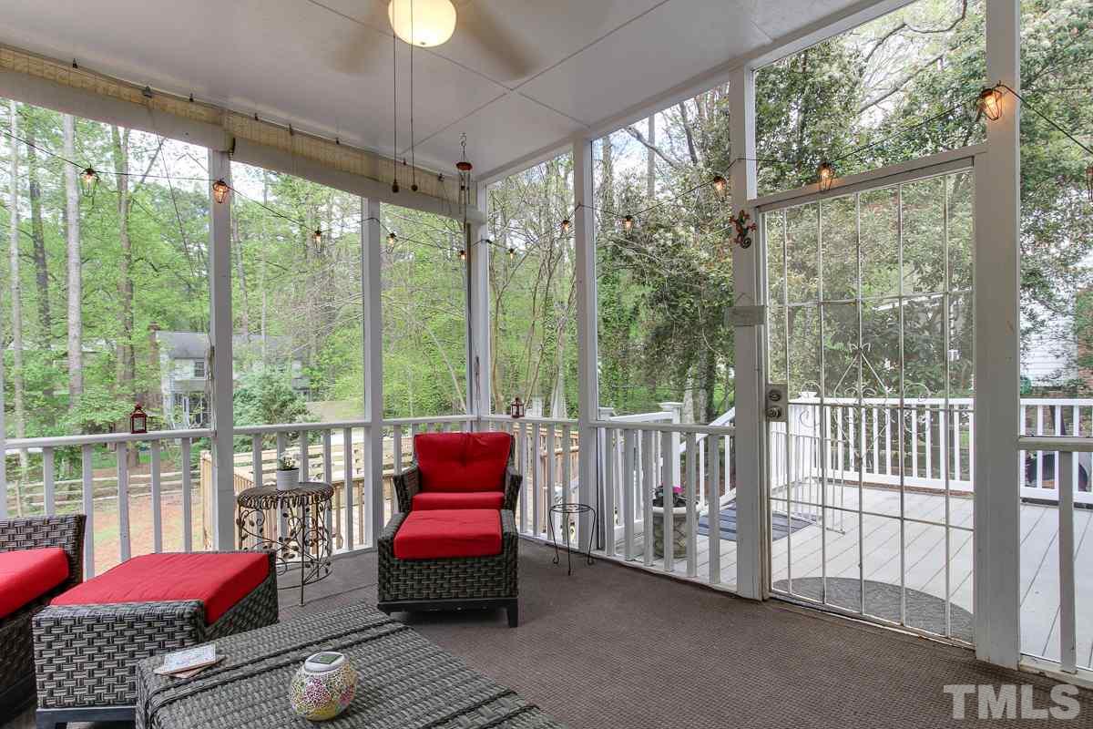 2000 Corberrie Lane Raleigh, NC 27613 - Photo 23 of 25 a living room with furniture and a floor to ceiling window