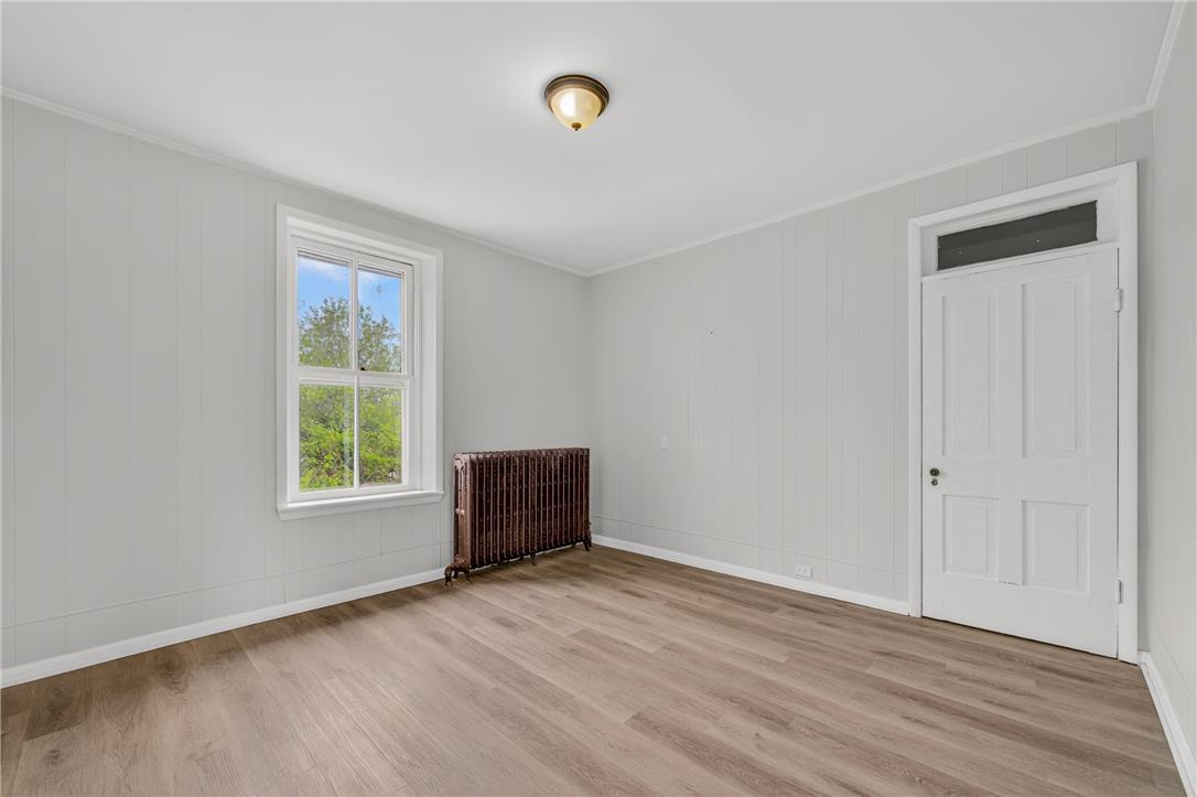 65 2nd Street Slatington, PA 18080 - Photo 35 of 46 This naturally illuminated room features light wooden flooring and a classic radiator, creating a cozy and functional space.
