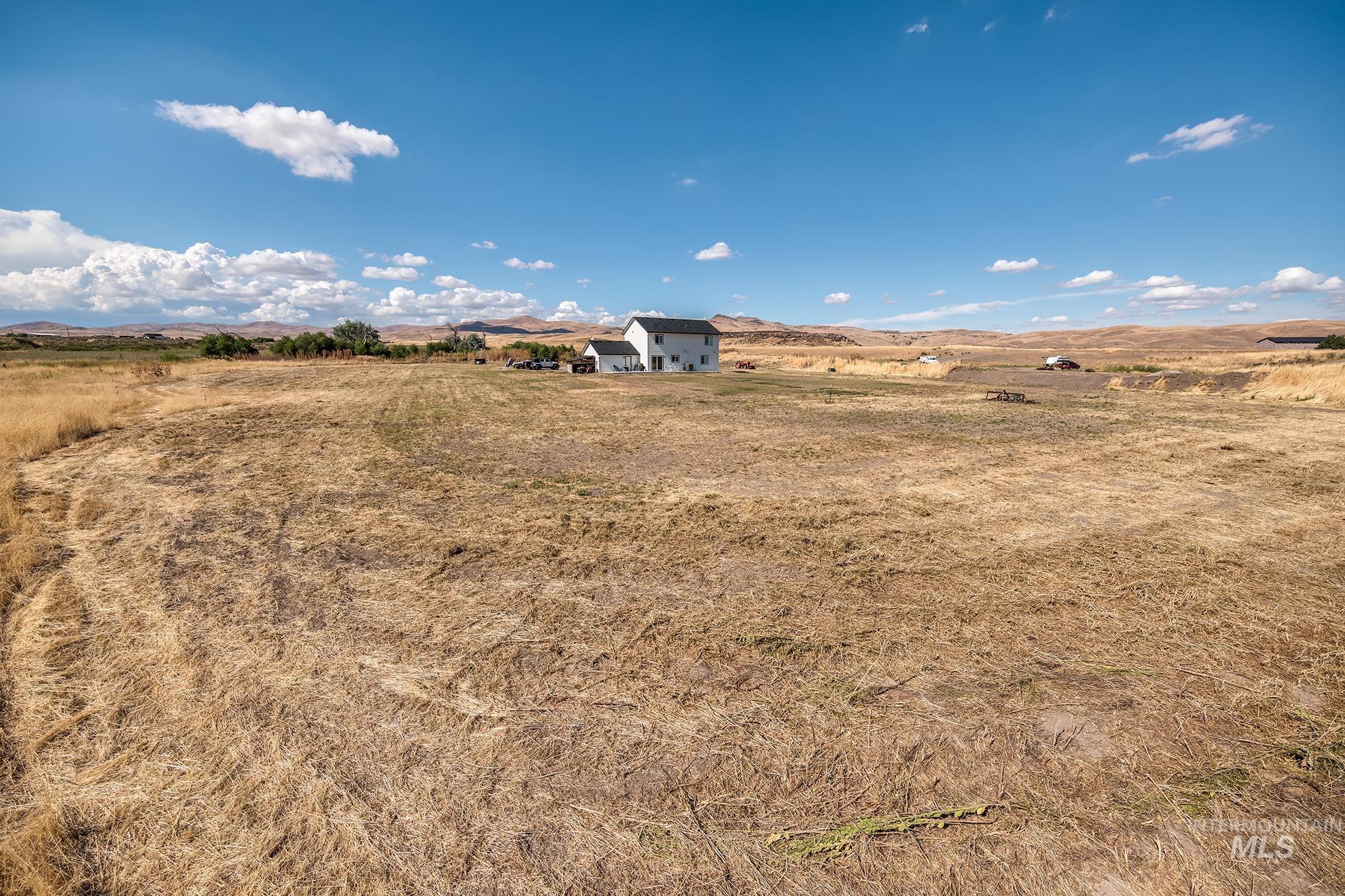 1049 Price Road Weiser, ID 83672 - Photo 42 of 47 Expansive land parcel featuring a distant single-family home