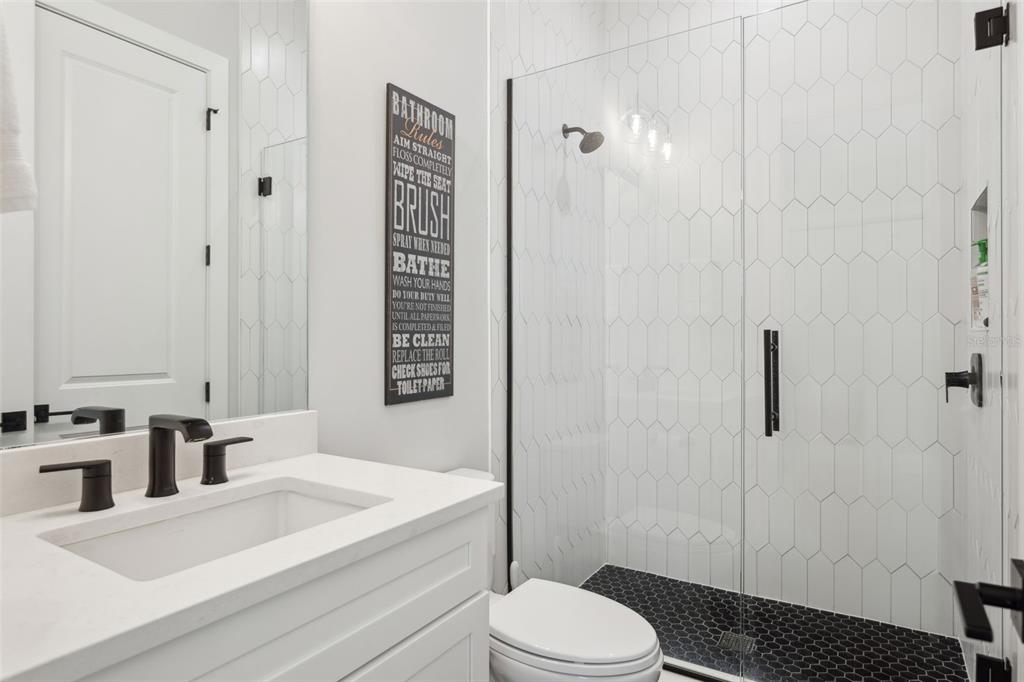 4515 West North A Street, Unit 2 Tampa, FL 33609 - Photo 16 of 21 a bathroom with a sink a toilet and shower