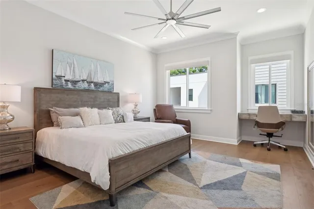 a spacious bedroom with a bed and a flat tv screen