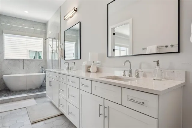 a white bath tub sitting next to a white sink
