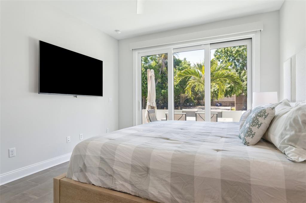 4515 West North A Street, Unit 2 Tampa, FL 33609 - Photo 3 of 21 a bedroom with a bed and a flat screen tv