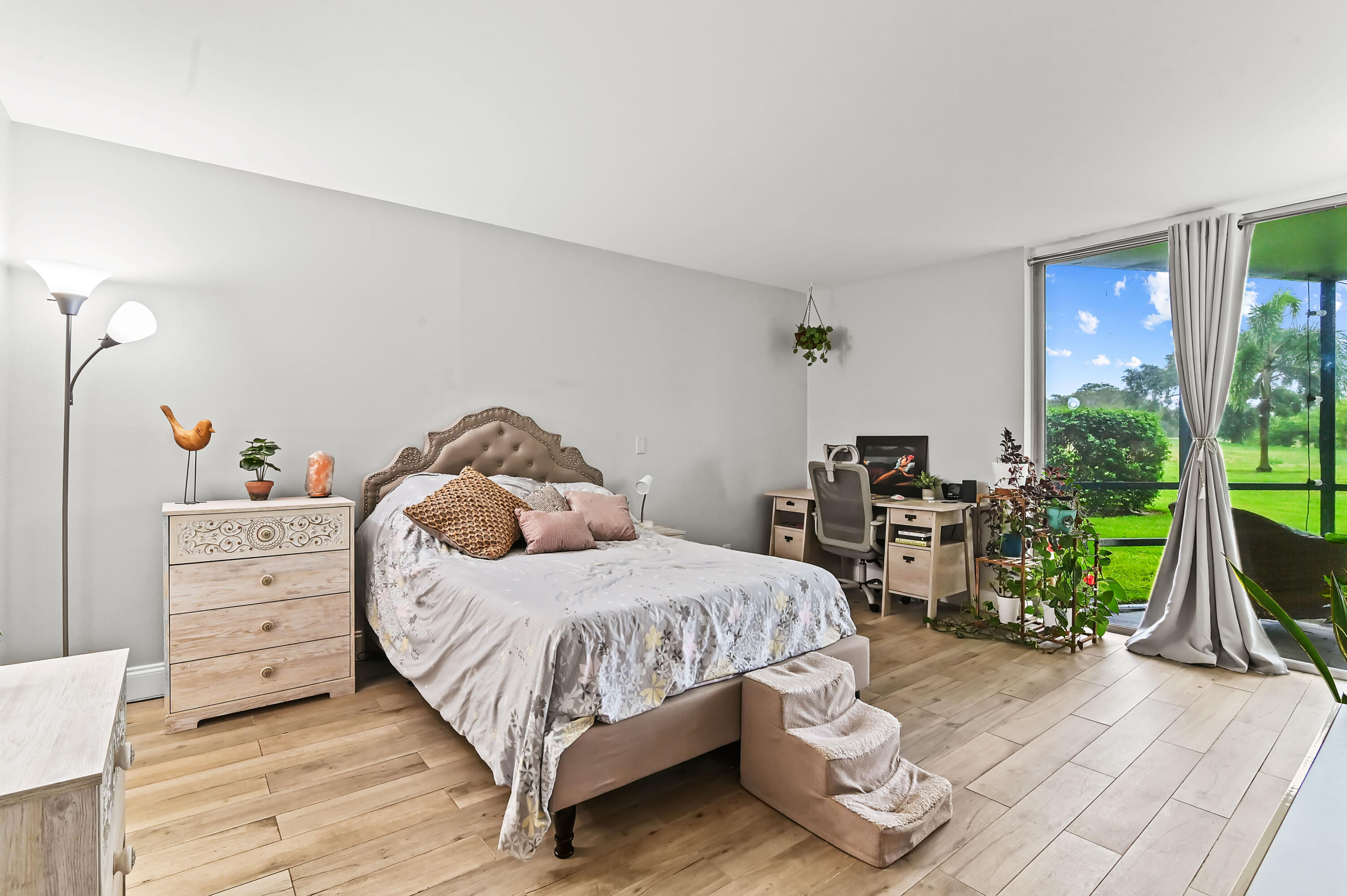 6400 Northwest 2nd Avenue, Unit 124 Boca Raton, FL 33487 - Photo 18 of 33 a bedroom with a bed and large windows