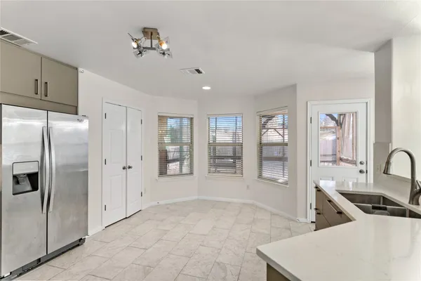 a view of a livingroom with wooden floor and a ceiling fan