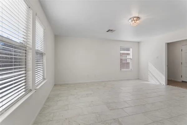 a view of a room with wooden floor and a ceiling fan