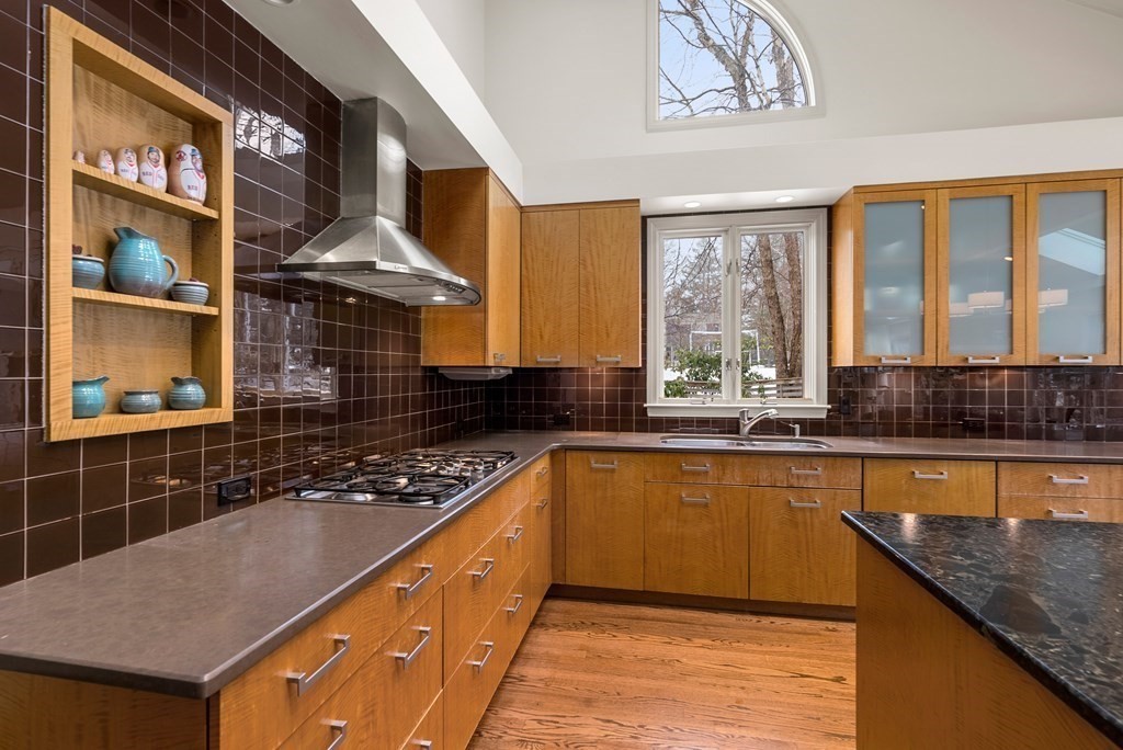 326 Highland Avenue Newton, MA 02465 - Photo 11 of 42 a kitchen with stainless steel appliances granite countertop a sink stove and cabinets