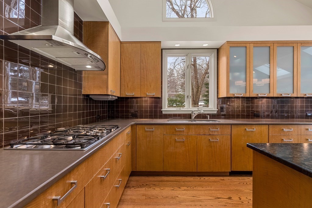 326 Highland Avenue Newton, MA 02465 - Photo 12 of 42 a kitchen with stainless steel appliances a stove sink and cabinets