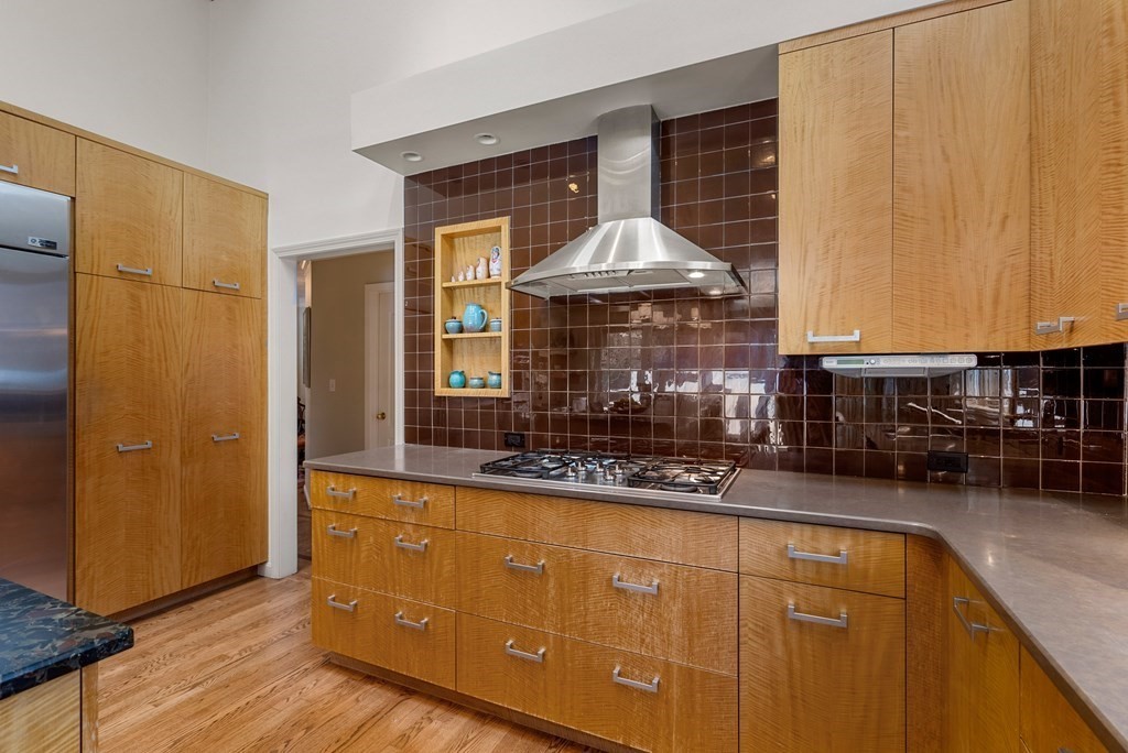 326 Highland Avenue Newton, MA 02465 - Photo 13 of 42 a kitchen with stainless steel appliances granite countertop a stove and a refrigerator