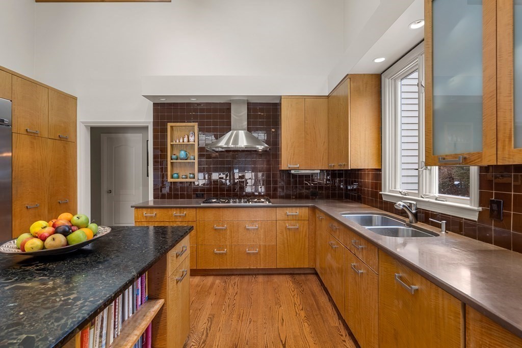 326 Highland Avenue Newton, MA 02465 - Photo 14 of 42 a kitchen with stainless steel appliances granite countertop a sink a stove and a wooden floors