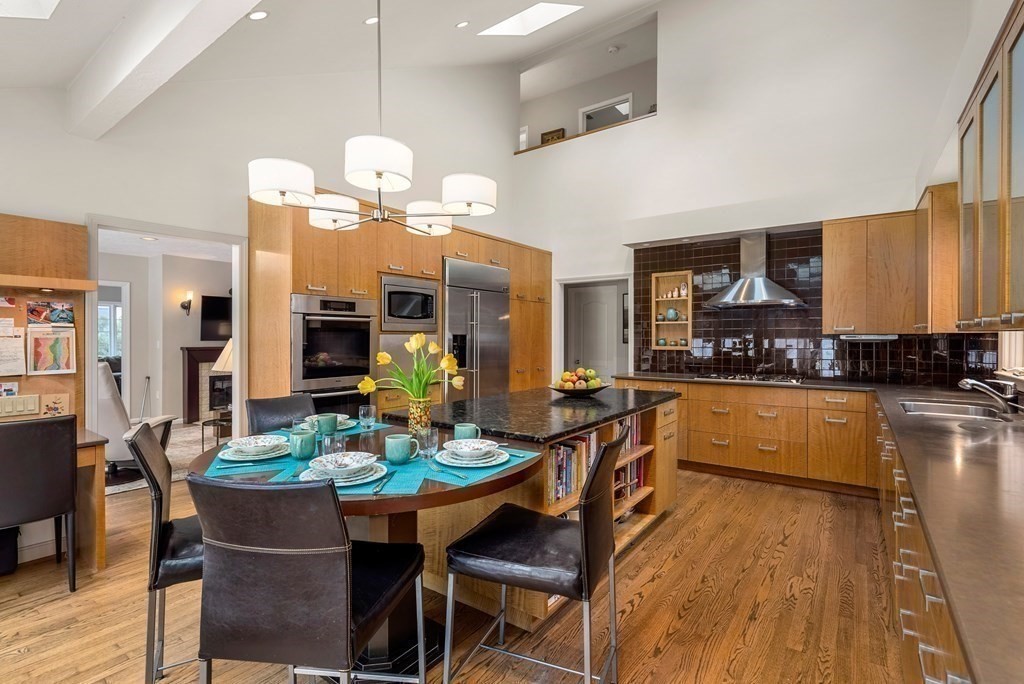 326 Highland Avenue Newton, MA 02465 - Photo 16 of 42 a dining room filled chandelier and wooden floor