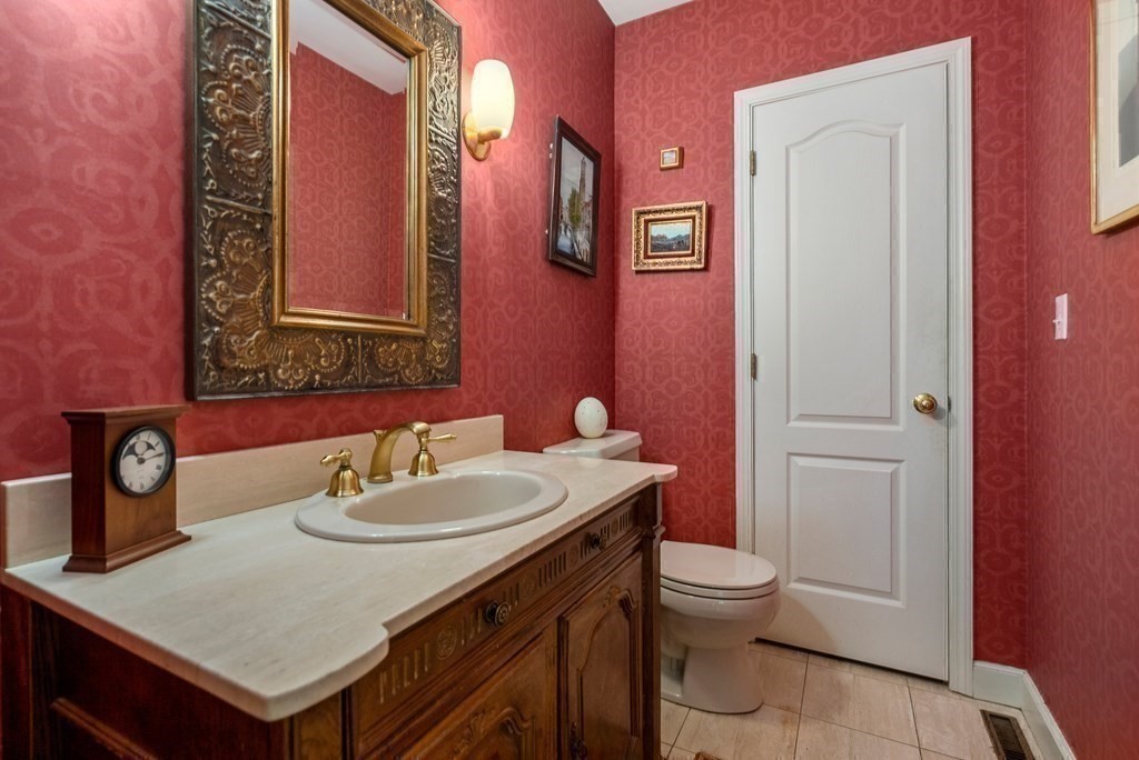 326 Highland Avenue Newton, MA 02465 - Photo 23 of 42 a bathroom with a sink a toilet and mirror