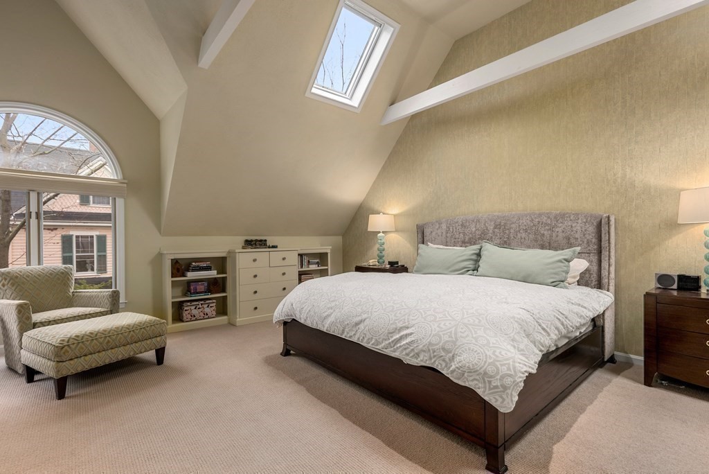 326 Highland Avenue Newton, MA 02465 - Photo 24 of 42 a spacious bedroom with a bed and a couch