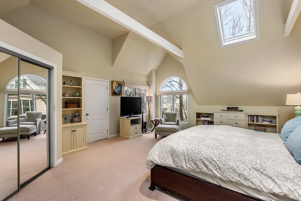 326 Highland Avenue Newton, MA 02465 - Photo 26 of 42 a spacious bedroom with a bed a table and large window with kitchen view