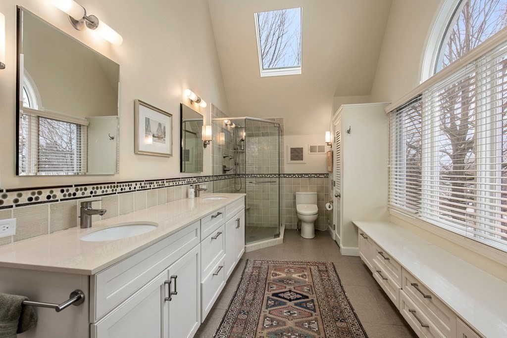 326 Highland Avenue Newton, MA 02465 - Photo 27 of 42 a bathroom with a double vanity sink a toilet and a bathtub