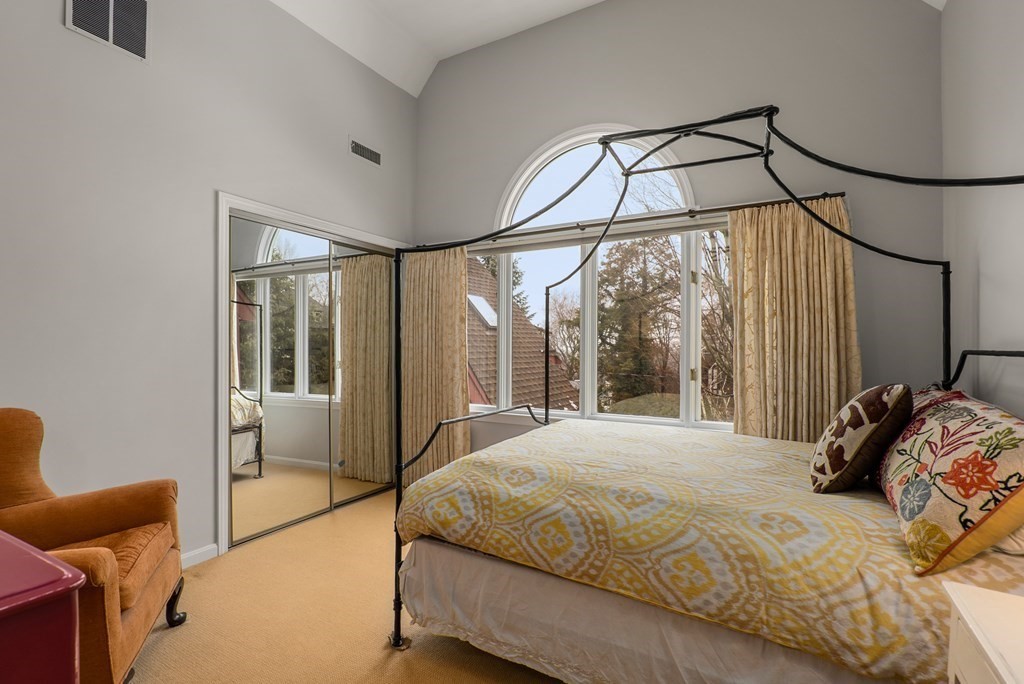 326 Highland Avenue Newton, MA 02465 - Photo 30 of 42 a bedroom with a bed and a mirror