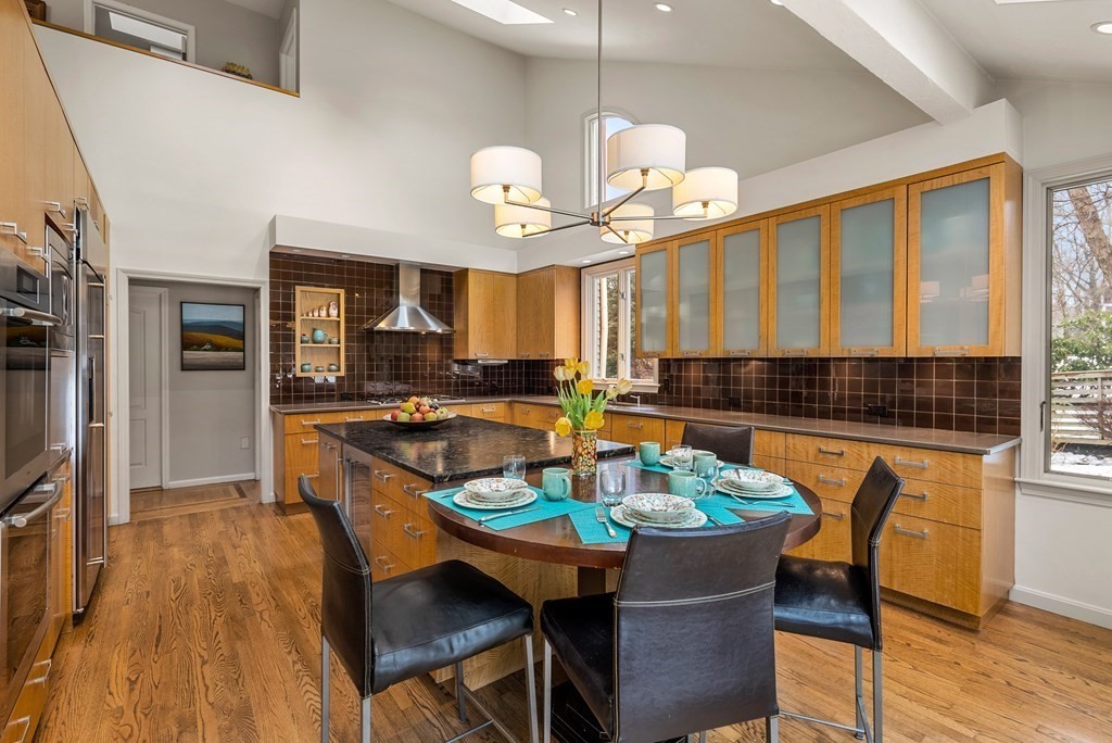 326 Highland Avenue Newton, MA 02465 - Photo 9 of 42 a kitchen with a dining table and chairs