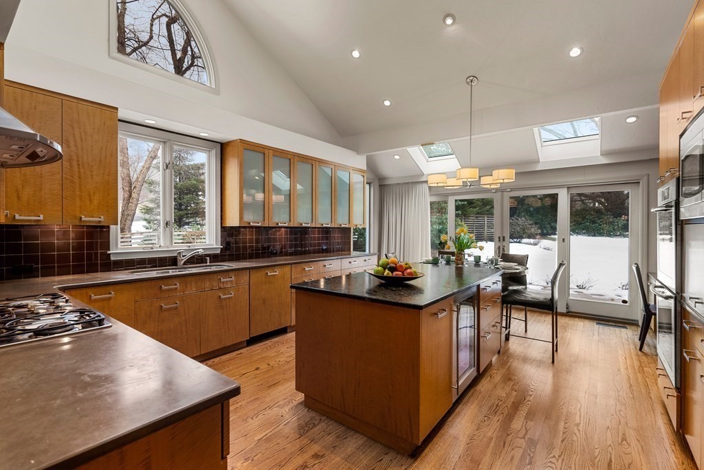 326 Highland Avenue Newton, MA 02465 - Photo 10 of 42 a kitchen with stainless steel appliances granite countertop a sink a stove and a wooden floors