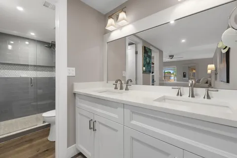 a bathroom with a sink double vanity and a mirror