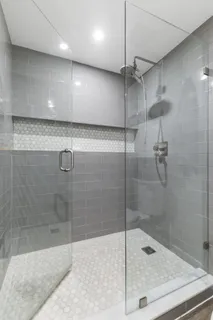 a bathroom with a shower and a sink
