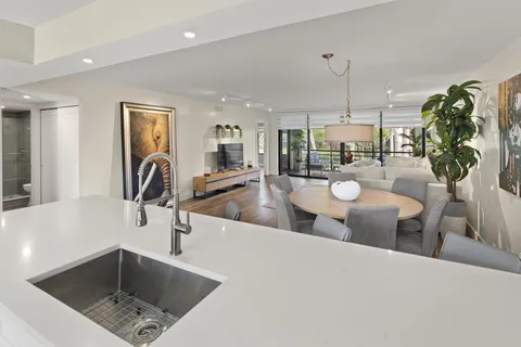 a kitchen with stainless steel appliances granite countertop a sink a stove and cabinets