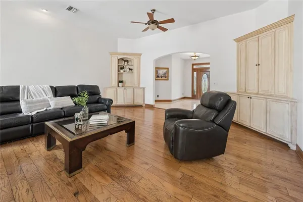a dining room with furniture a chandelier and wooden floor