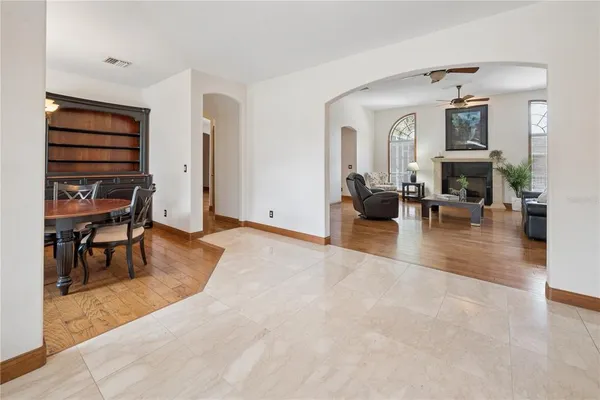 a kitchen with stainless steel appliances granite countertop a stove a sink and a refrigerator with wooden floors