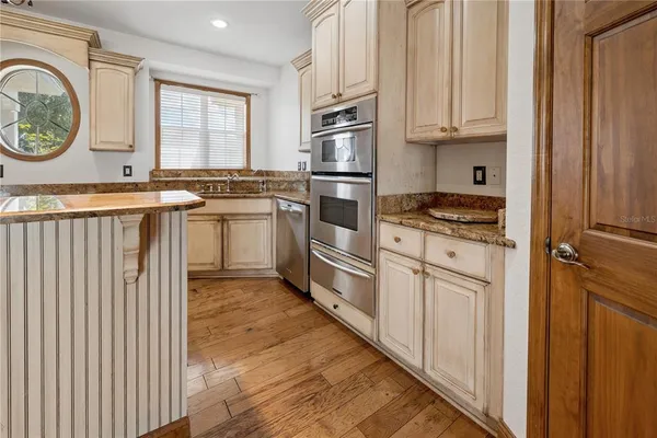 a kitchen with kitchen island granite countertop a stove and a refrigerator