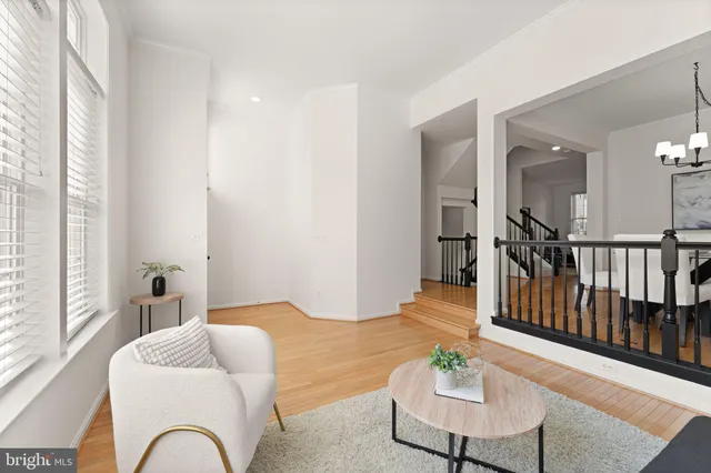 a view of staircase with lots of frames on wall and windows